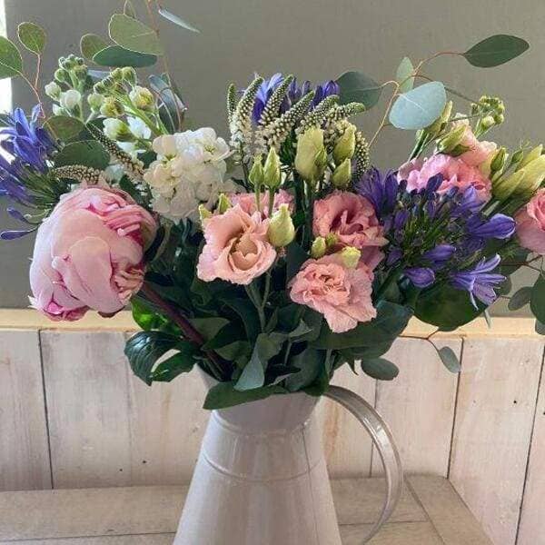 lovely mixed flowers bouquet arranged in a jug