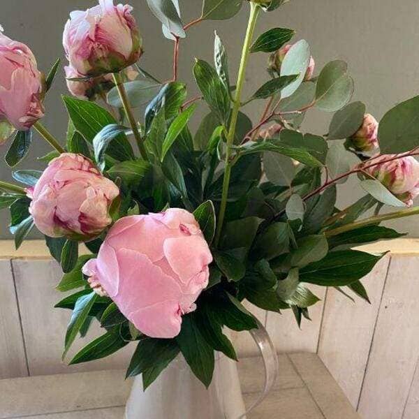 pinks and foliages bouquet in a jug