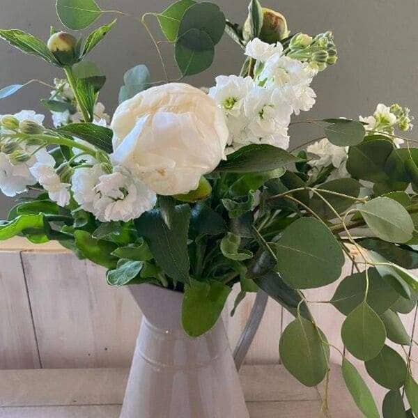 All whites and foliages bouquet arranged in a jug